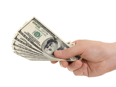 A hand holding hundred dollar bills.